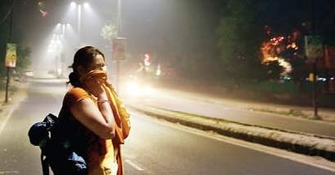 A woman covers her face in the smog-filled Vasant Kunj area in New Delhi on Diwali night | Shekhar Yadav