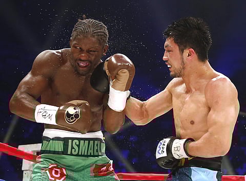 French champion Hassan N'Dam N'Jikam, left, gets a right from Japanese challenger Ryota Murata in the 12th round of their WBA middleweight boxing world title match in Tokyo. (File | AP)