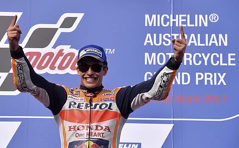 Spain's MotoGP rider Marc Marquez celebrates on the podium after winning the Australian Motorcycle Grand Prix. | AP