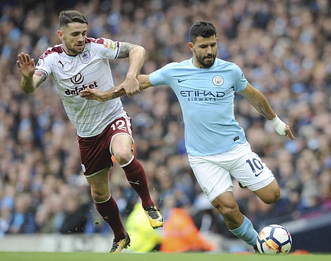 Manchester City's Sergio Aguero, right, and Burnley's Robbie Brady battle for the ball during the EPL match. | AP