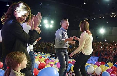 Argentina's President Mauricio Macri, center, dances with Buenos Aires Gov. Maria Eugenia Vidal, right, as his wife Juliana Awada claps after midterm legislative elections in Buenos Aires, Argentina.|AP