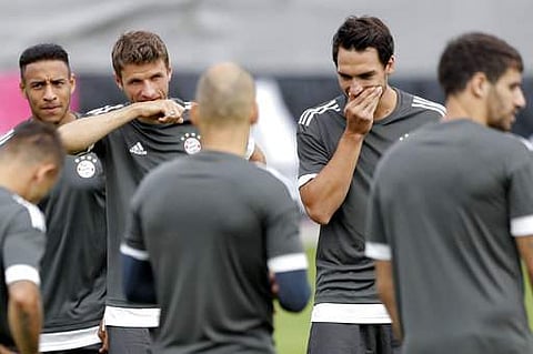 Bayern's Thomas Mueller, rear 2nd left, covers his face besides team mate Mats Hummels, rear right, during a training session in Munich. | AP