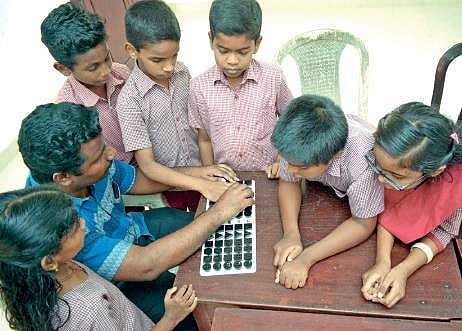 Vinod B explains the calculations using Equation board for visually challenged, to his students at Government School for Visually Impaired at Vazhuthacaud Manu R Mavelil