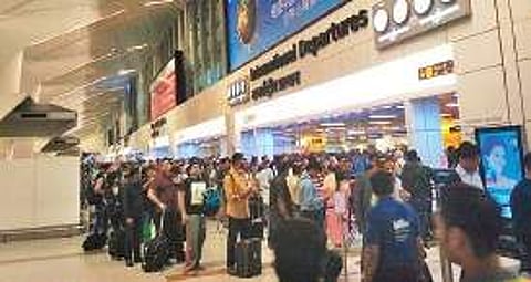 People wait for their turn at the IGI Airport for immigration formalities | Express