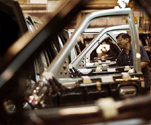 An engineer work on cars lined up at manufacturing plant near Pune. (File photo | Reuters)