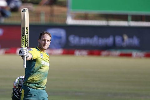 South African batsman David Miller raises his bat and helmet as he celebrates scoring a century (100 runs) during the second T20 cricket match between South Africa and Bangladesh.|AFP