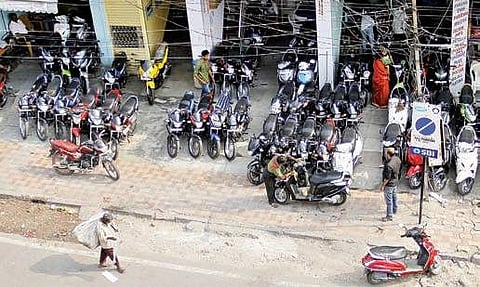 Footpath at Koti King road has been enchroached by second hand bike sellers due to lack of a parking space | sathya keerthi