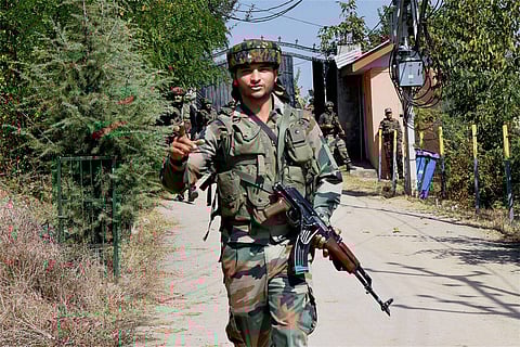 Srinagar Security personnel take positions during an operation after militants stormed a BSF camp early morning near Srinagar International Airport on Tuesday. | PTI