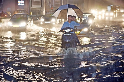 Rain water flows on the roads of Sardar Patel road, Begumpet, in Hyderabad. (EPS | R.Satish Babu)