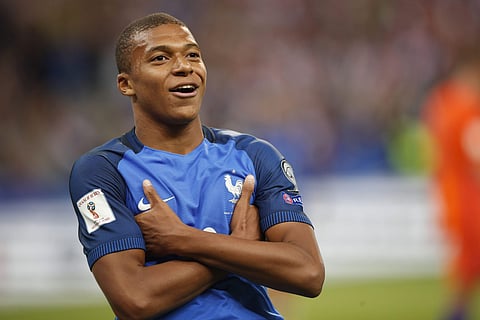 France's Kylian Mbappe reacts after scoring France' s fourth goal during the World Cup Group A qualifying soccer match between France and The Netherlands at the Stade de France stadium. | AP