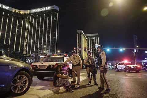 Police officers stand at the scene of a shooting near the Mandalay Bay resort and casino on the Las Vegas Strip. (Photo | AP)