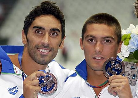 In this Sunday, Aug. 2, 2015, men's 4x100m freestyle relay team Italy's Filippo Magnini, left, and Michele Santucci hold up their bronze medals at the Swimming World Championships in Kazan, Russia. | AP