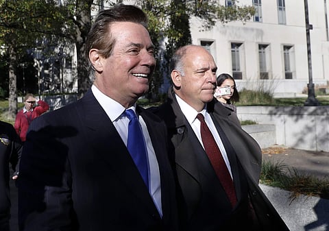 Paul Manafort, left, leaves Federal District Court in Washington, Monday, Oct. 30, 2017. (Photo | Associated Press)