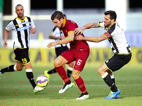 In this file photo, Roma's Kevin Strootman, center, and Udinese's Maurizio Domizzi, right, challenge for the ball during a Serie A soccer match between Udinese and Roma at the Friuli Stadium in Udine, Italy, Tuesday, Jan. 6, 2015. (AP)