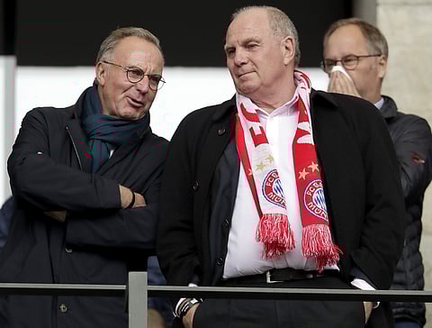 Bayern's club president Uli Hoeness, right, the member of the board, Karl-Heinz Rummenigge, left, talk as they arrive for the German Bundesliga soccer match between Hertha BSC Berlin and FC Bayern Munich in Berlin. | AP