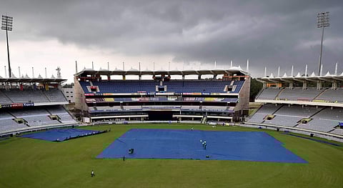 Groundsmen cover the pitch as dark clouds are seen in the sky over JSCA Stadium in Ranchi on Thursday ahead of 1st T20 Match between India and Australia. | PTI