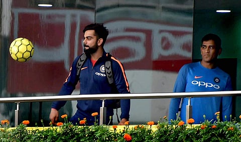 Skipper Virat Kohli and MS Dhoni play with a football at the dressing room at JSCA Stadium in Ranchi on Friday ahead of the 1st T20 Match against Australia. | PTI