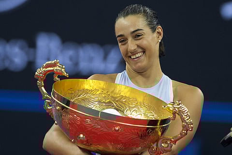 Caroline Garcia of France holds the trophy after defeating Simon Halep of Romania in the women's singles final match in the China Open tennis tournament. (Photo | AP)