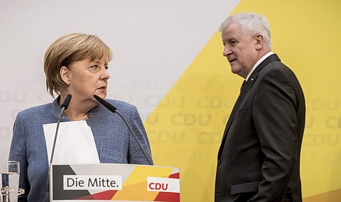 German Chancellor Angela Merkelof the German Christian Democratic Union, CDU, left, and Bavaria's State Governor Horst Seehofer, right, of the Christian Social Union, CSU, arrive for a news conference in Berlin. (AP)