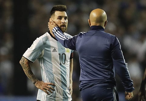 Argentina's Lionel Messi, left, is comforted by Argentina coach Jorge Sampaoli after a World Cup qualifying soccer match at La Bombonera stadium in Buenos Aires, Argentina, Thursday, Oct. 5, 2017. | AP