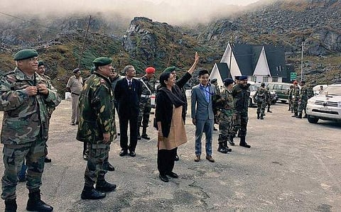 Nirmala Sitharaman waves at the Chinese soldiers during her maiden visit to the Nathu La border. (Photo | PTI)