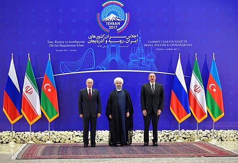 Iranian President Hassan Rouhani, center, Russian President Vladimir Putin, left, and Azerbaijan's President Ilham Aliyev, pose for a photograph prior to their trilateral meeting in Tehran, Iran. | AP