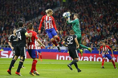 Qarabag goalkeeper Ibrahim Sehic, saves as Atletico's Antoine Griezmann jumps during a Group C Champions League soccer match between Atletico Madrid and Qarabag at the Metropolitano stadium. | AP