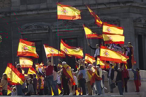People wave Spanish flags during a mass protest by people angry with Catalonia's declaration of independence. (Photo | AP)