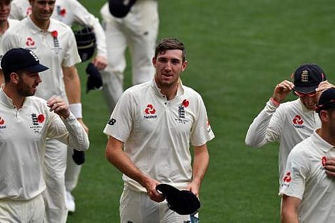 England's paceman Craig Overton (C) walks off the field with teammates following their victory against Cricket Australia XI on the last day of a four-day Ashes tour match at Adelaide Oval in Adelaide on November 11, 2017. | AFP