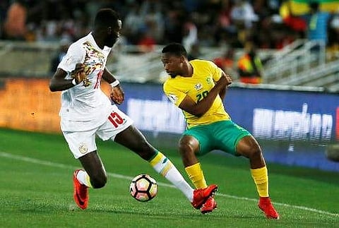 South Africa's midfielder Sibusiso Vilakazi (R) vies for the ball with Senegal's midfielder Salif Sane during the FIFA World Cup 2018 qualification football match between South Africa and Senegal at the Peter Mokaba Stadium in Polokwane on November 10, 20