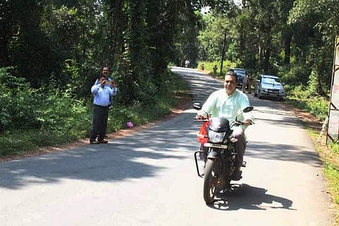 District-in-charge minister Pramod Madhwaraj taking a joy-ride on a bike without wearing a helmet on Thursday. (Express Photo Service)