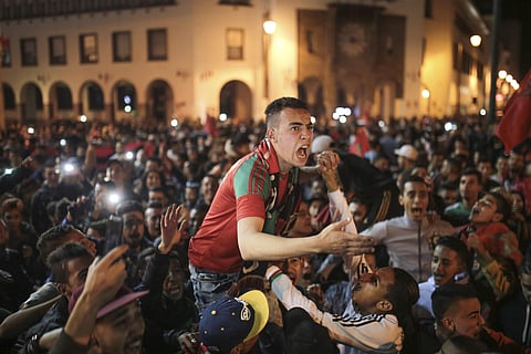 Moroccans celebrate their team's qualifying for the World Cup for the first time since 1998, in Rabat, Morocco. | AP