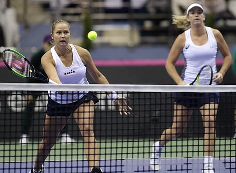 United States' CoCo Vandeweghe, right, looks on as her teammate Shelby Rogers, left, returns a ball to Belarus' Aliaksandra Sasnovich and Aryna Sabalenka during the Fed Cup final. | AP