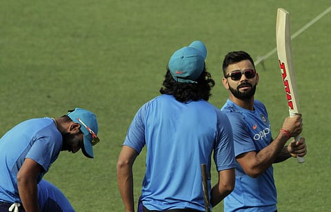 India's Virat Kohli, right, attends a practice session with teammates prior to their first test cricket match against Sri Lanka at Eden Gardens in Kolkata. | AP
