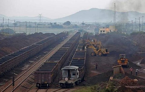 Freight trains are loaded with iron ore at a railway station at Chitradurga in Karnataka.(Photo | Reuters)