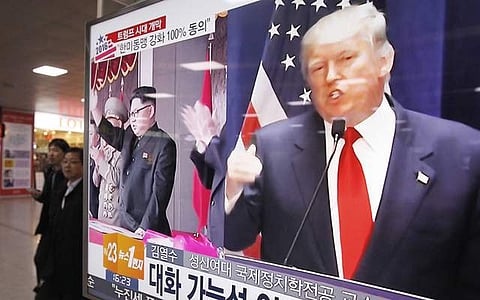 In this Nov. 10 photo, a TV screen shows pictures of U.S. President-elect Donald Trump, right, and North Korean leader Kim Jong Un, at the Seoul Railway Station in Seoul. (Photo | Associated Press)
