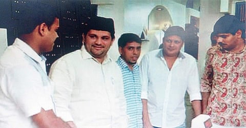 Muslim Youth League state president Munavarali Shihab Thangal is seen along with wanted gold smugglers Shahbaz (extreme right) and Karat Faizal (extreme left)