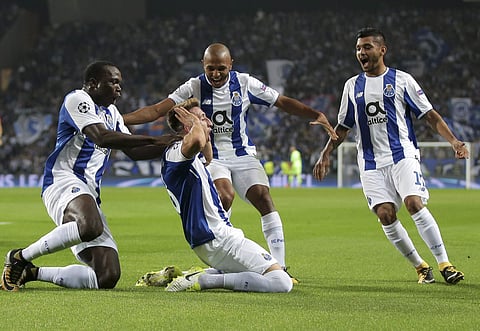Porto's Hector Herrera, center, on the ground, celebrates after scoring the opening goal during the Champions League group G soccer match between FC Porto and RB Leipzig at the Dragao stadium in Porto, Portugal, Wednesday, Nov. 1, 2017. | AP