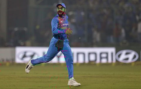 Indian captain Virat Kohli celebrates the dismissal of New Zealand's Martin Guptill during their first T20 match in New Delhi, India, Wednesday. | AP