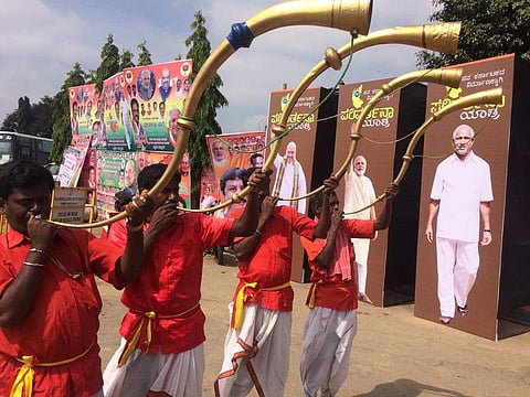 Folk artists at the entrance of Parivarthana Yatra entrance in Bengaluru on Thursday. (Nagaraja Gadekal | EPS)