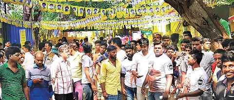 District functionaries of actor Karthi’s Fans Club, wearing custom made T-shirts, welcoming audience outside a theatre in Cuddalore | Express