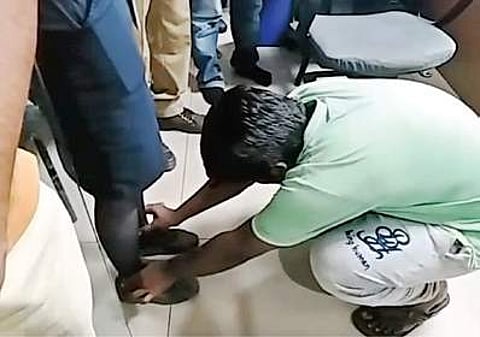A video grab showing the accused touching the feet of airline staff | Express