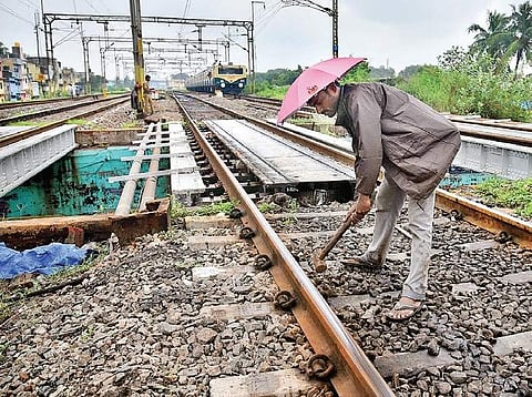 A track worker conducts maintenance checks | file photo
