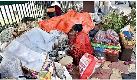 A slum dweller guarding her belongings at Necklace Road in Hyderabad on Tuesday | Vinay Madapu