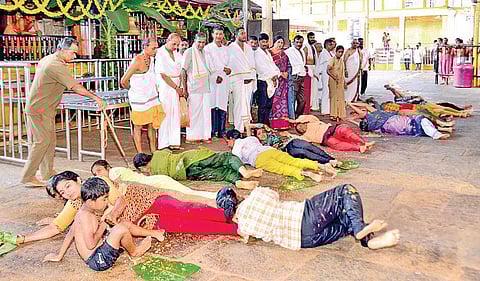Hundreds of devotees participate at the ‘Ede snana ritual’ by rolling on the plantain leaves at Kukke Subrahmanya temple on Wednesday