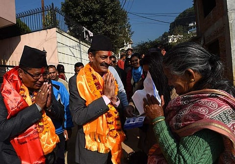Nepali Congress and Democratic alliance election candidate Nabindra Raj Joshi (C) gesturing as he takes part in a door-to-door in election campaign in Kathmandu. | AFP