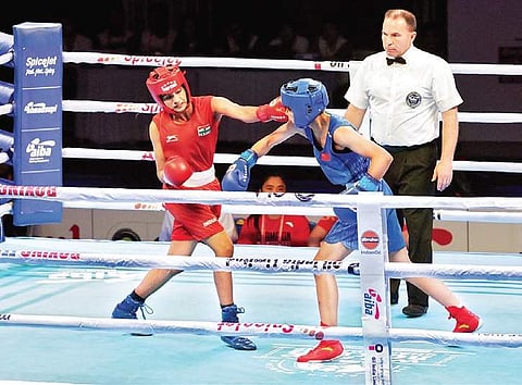India’s Nitu (left) lands a punch on Yuan Nie of China in the semifinals on Saturday