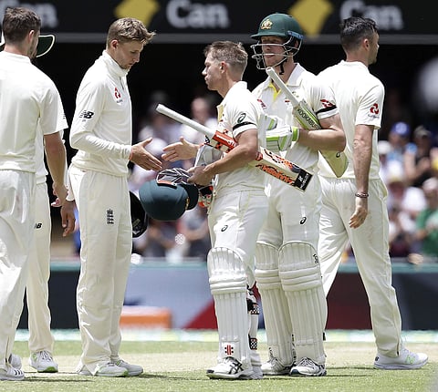 Australia's David Warner, center, and Cameron Bancroft, second from right, shake hands with England captain Joe Root, second from left, after winning the match during their Ashes cricket test in Brisbane, Australia, Monday, Nov. 27, 2017. | AP