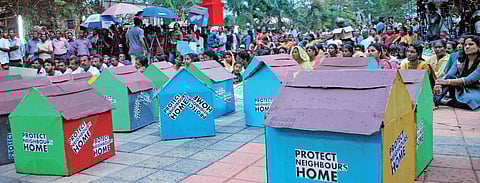 A file photo of the residents at Puthuvype who have been up in arms against the proposed IOC terminal, holding a protest meet at Rajendra Maidan with replica of houses, demanding the protection of their homes| K Shijith