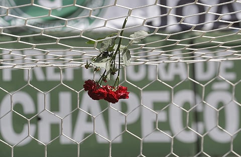 In this Nov. 29, 2016 file photo, flowers hang from a soccer net in honor of Chapecoense soccer players who died in a plane crash, during a memorial at Arena Conda stadium in Chapeco, Brazil. | AP
